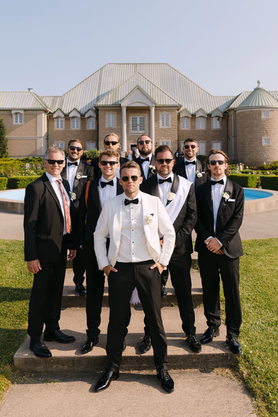 Groom and groomsmen posing at Chateau des Charmes wedding venue
