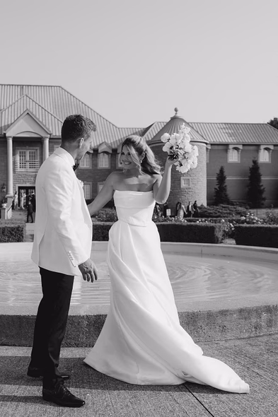 Bride and groom walking near fountain at Chateau des Charmes wedding