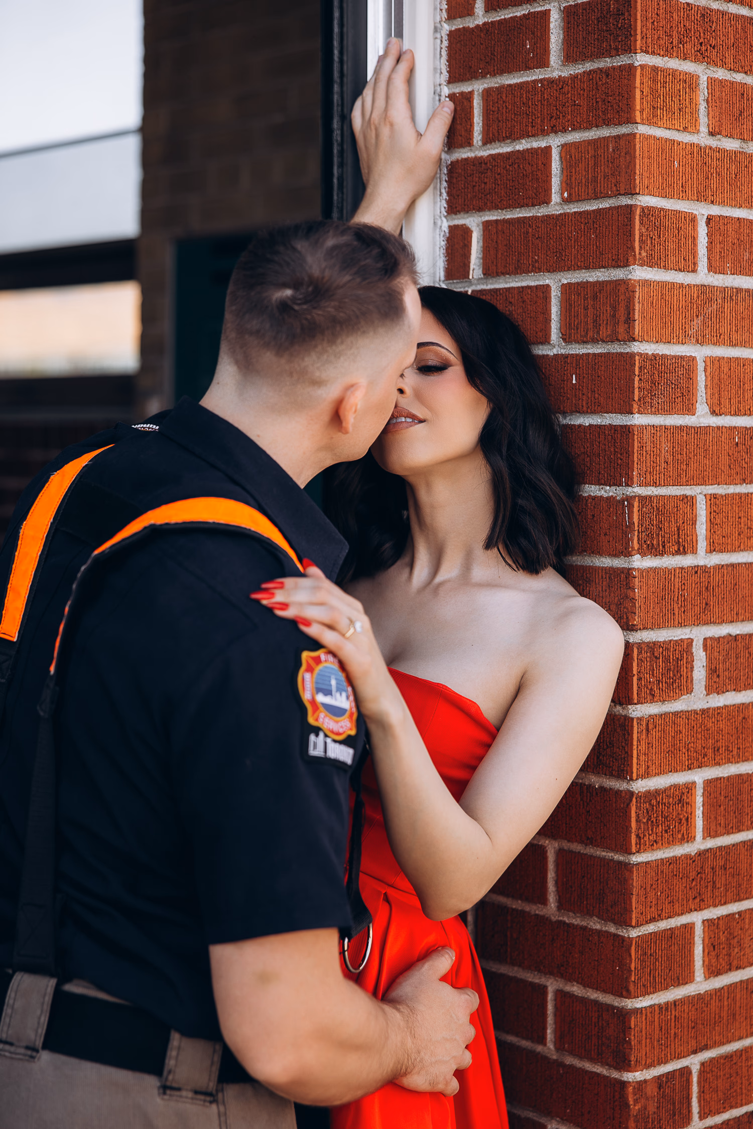 couple posing by fire truck