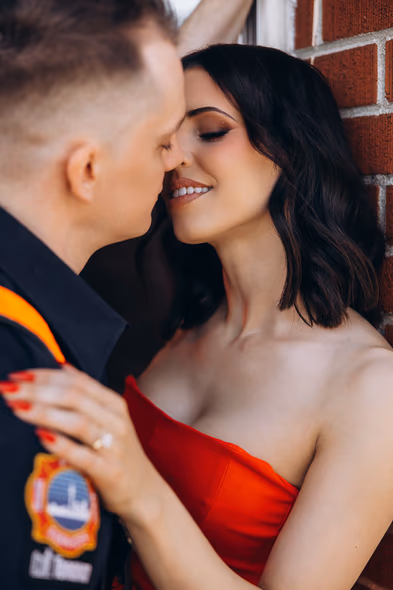firefighter couple posing in station