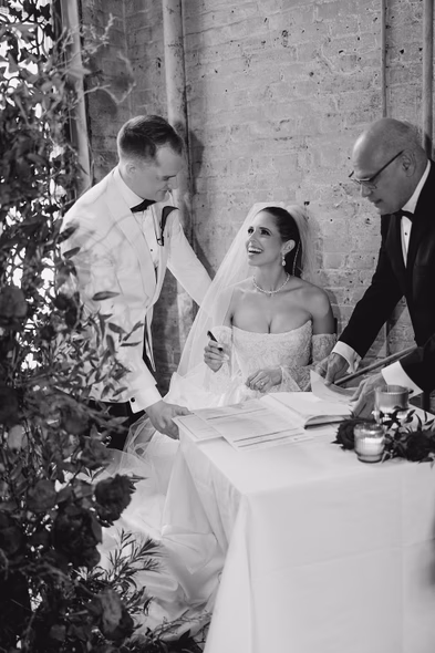Bride and groom signing at wedding ceremony George Restaurant Toronto