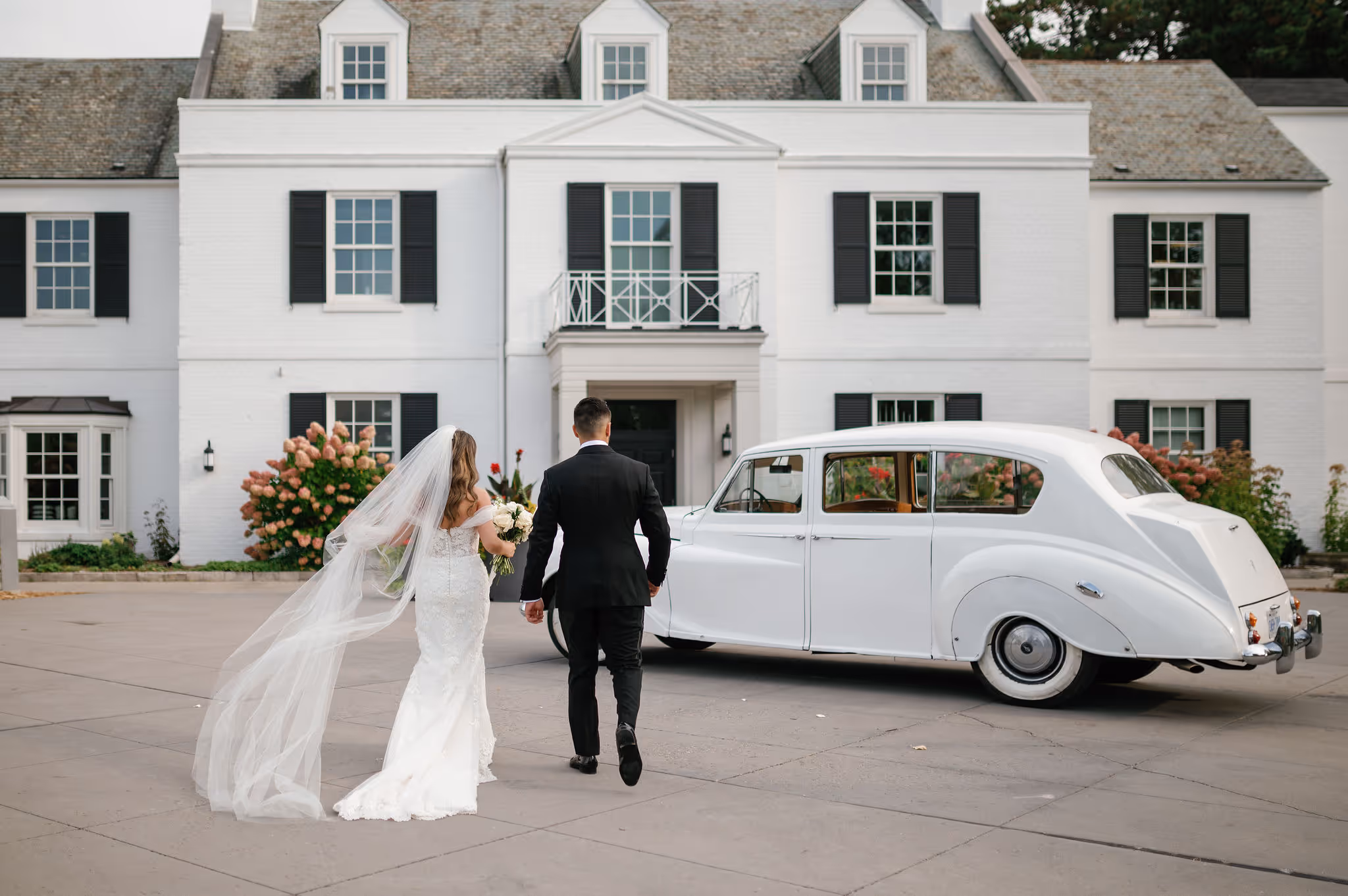 Harding Waterfront Estate brida and groom with a car
