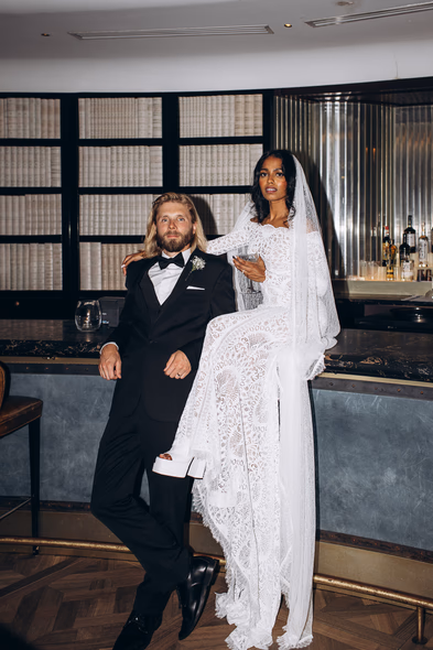groom and bride sitting at the bar