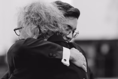 groom hugging his father at ceremony at St. Basil’s Catholic Parish