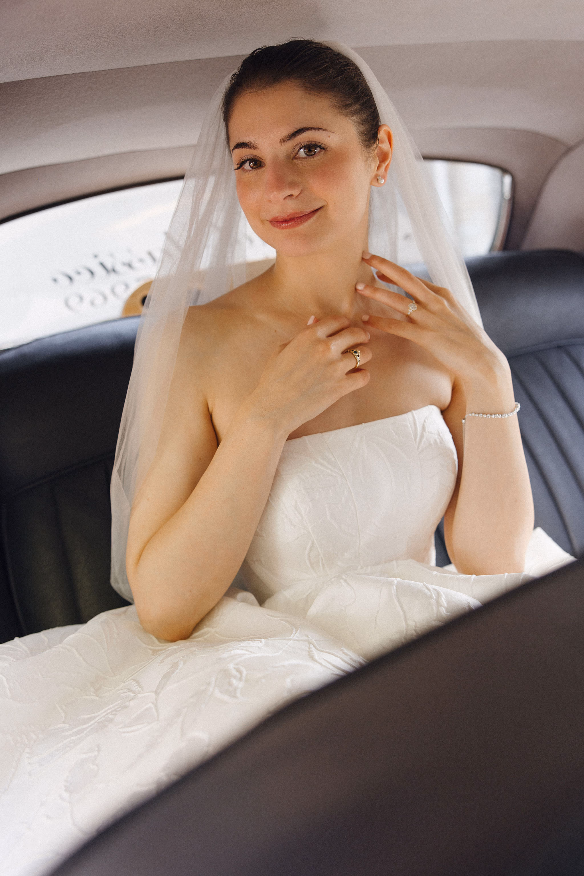 portrait of the bride sitting in a vintage car
