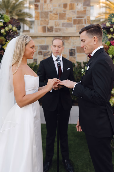 Bride placing ring on groom’s finger during Lido House ceremony