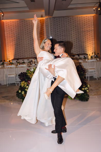 Bride and groom dancing joyfully at Lido House wedding reception