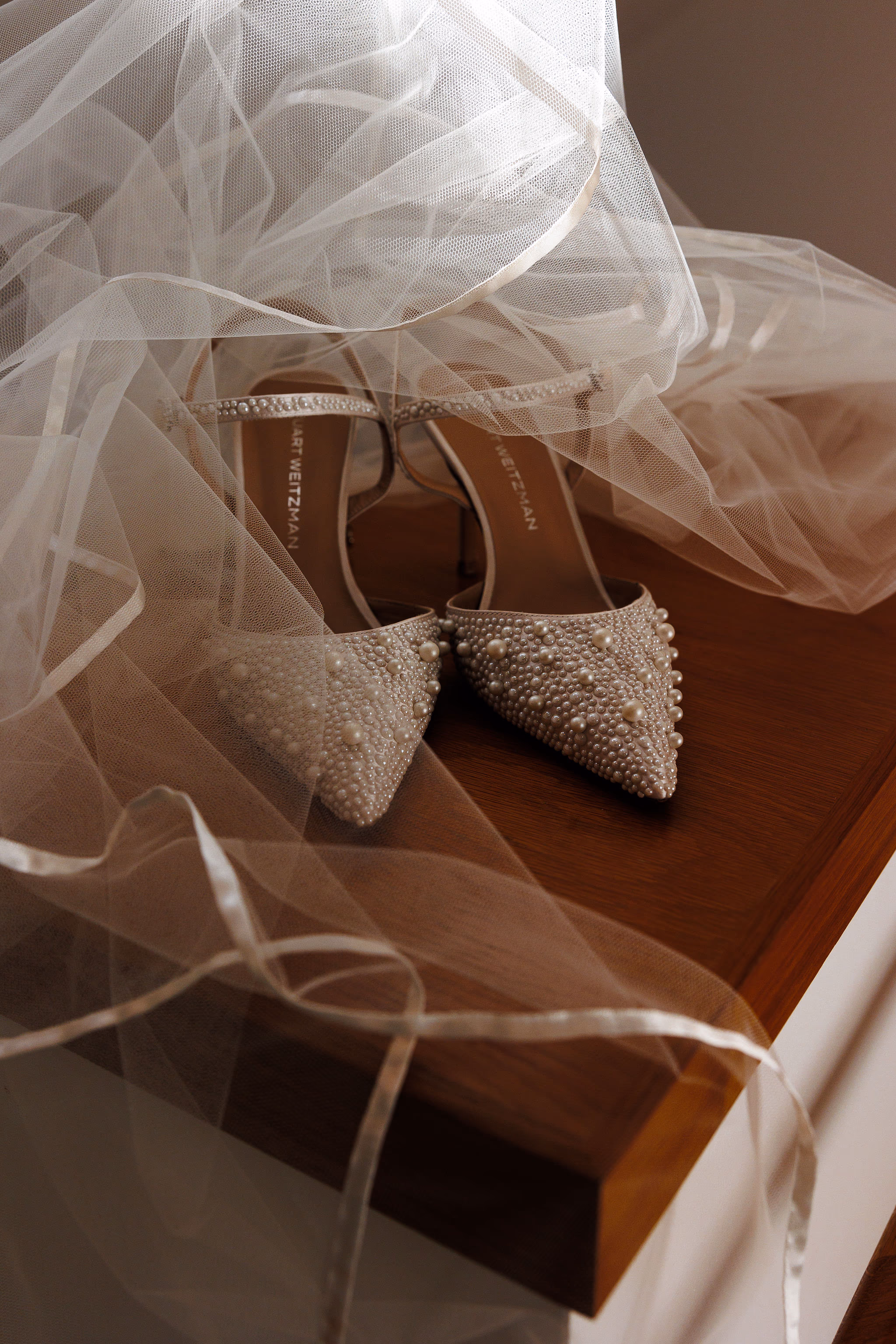 Bridal shoes adorned with jewels, placed under veil at Lido House