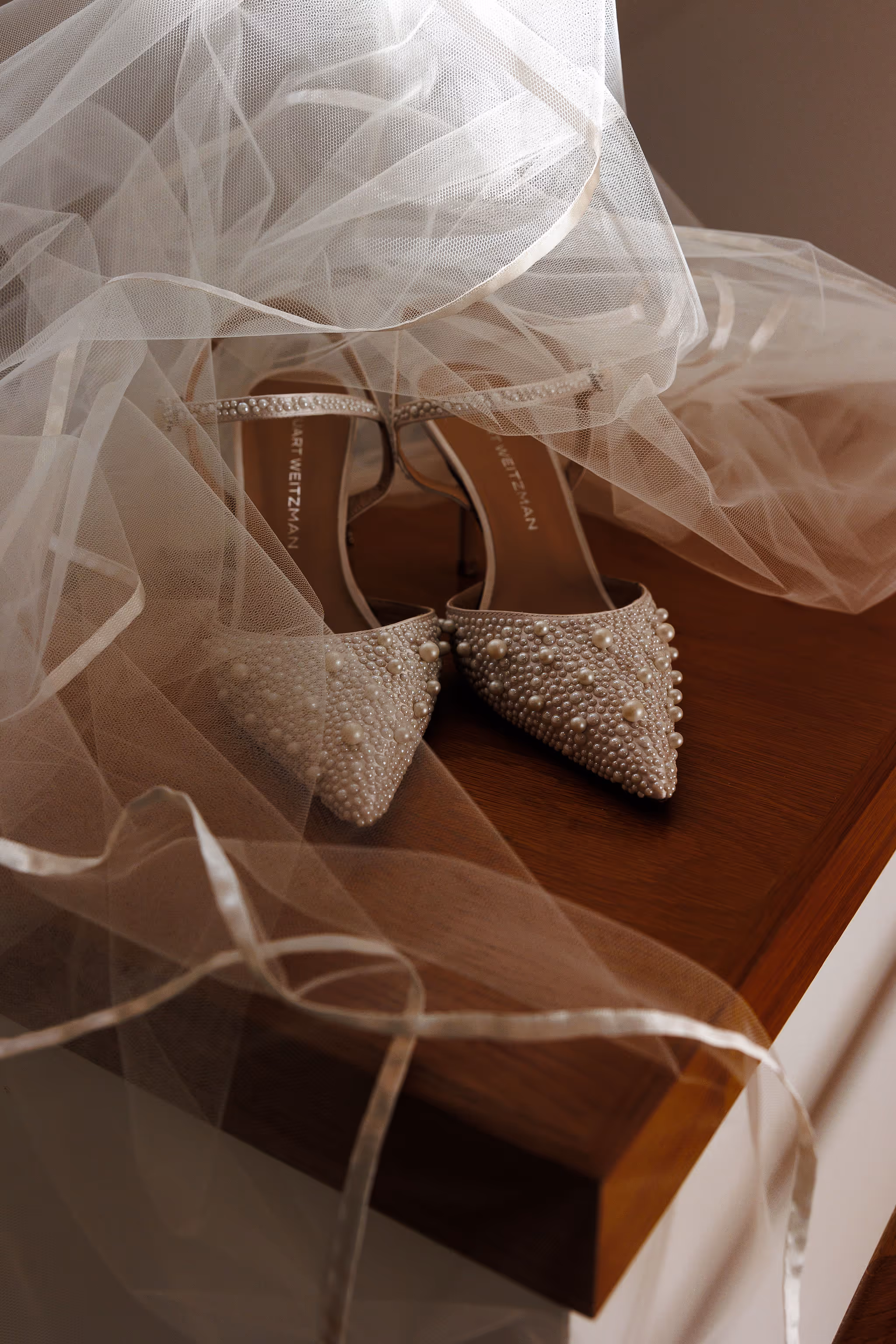 Bridal shoes adorned with jewels, placed under veil at Lido House