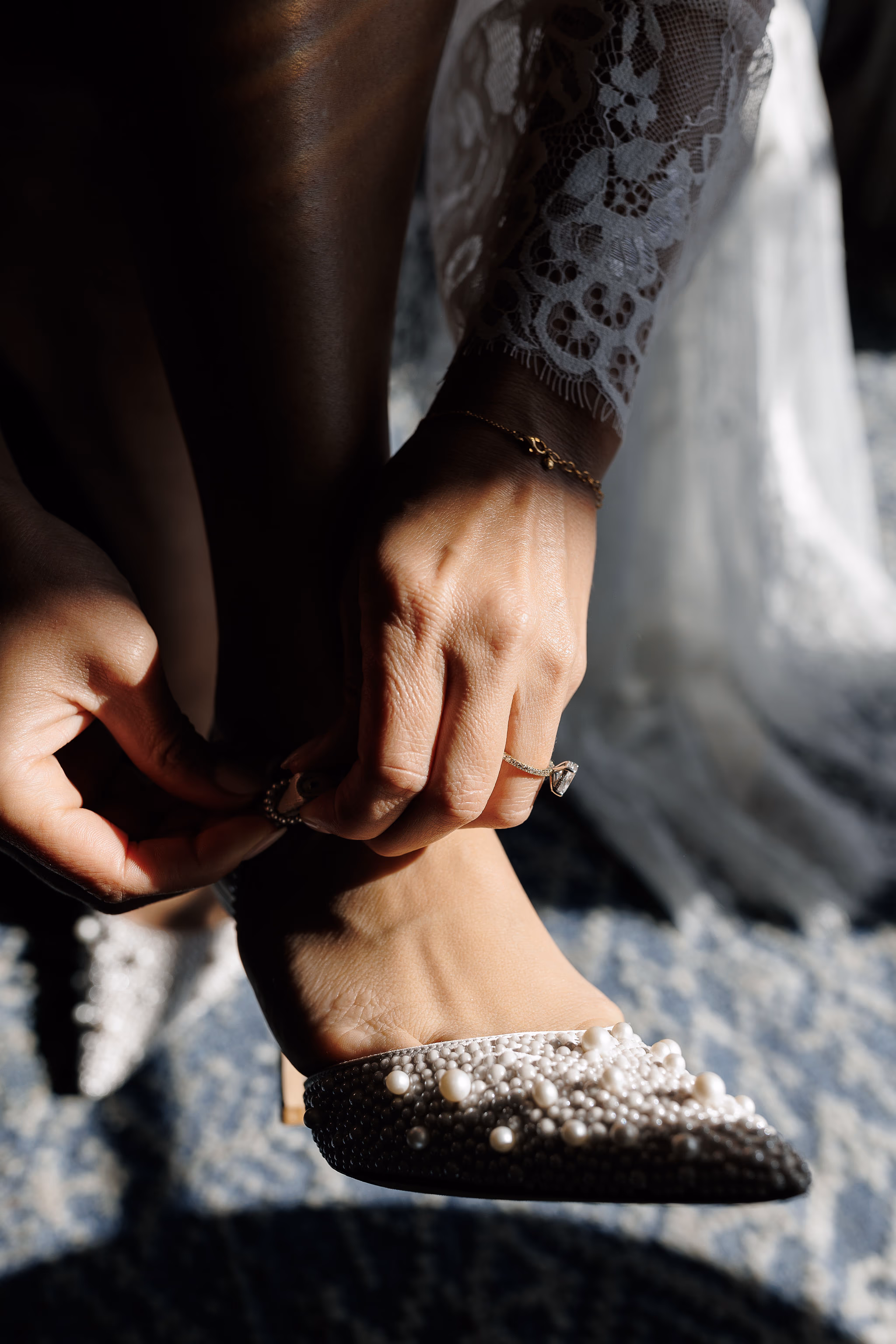Close-up of bride’s shoes being fastened at Lido House