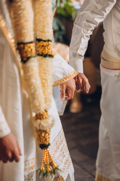 Close-up of hands during Tamil wedding ritual at Madison Greenhouse