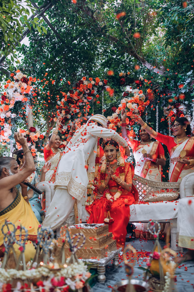 Tamil Hindu wedding rituals with family under floral mandap at Madison Greenhouse wedding