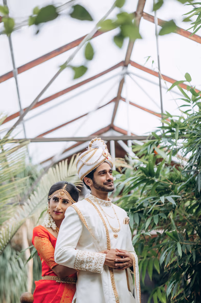 Couple portrait under glass roof at Madison Greenhouse wedding venue in Ontario