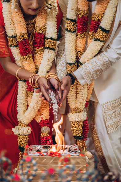 Bride assisting groom during Hindu Tamil wedding at Madisons Greenhouse