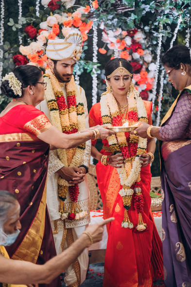 Bride in red saree during Tamil wedding ceremony at Madison Greenhouse wedding