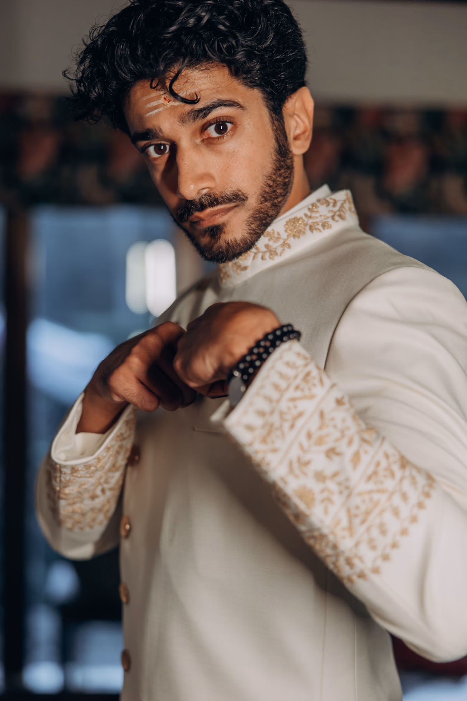 Groom adjusting sleeve before Tamil wedding ceremony at Madison Greenhouse wedding venue