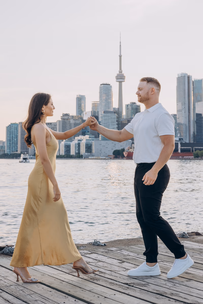 Toronto skyline engagement photo at Polson Pier