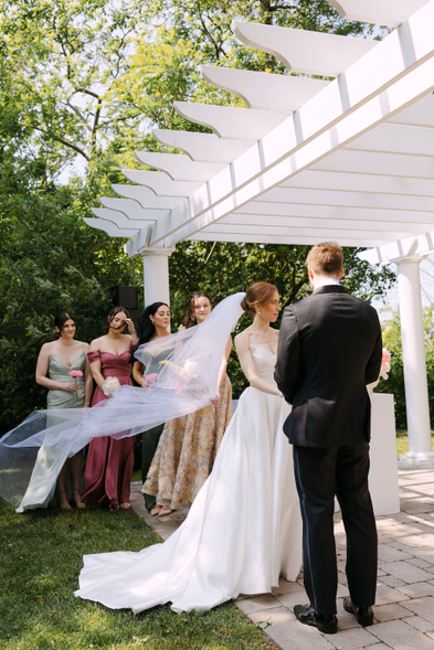 outdoor wedding ceremony under pergola bridal party Queen’s Landing Niagara-on-the-Lake