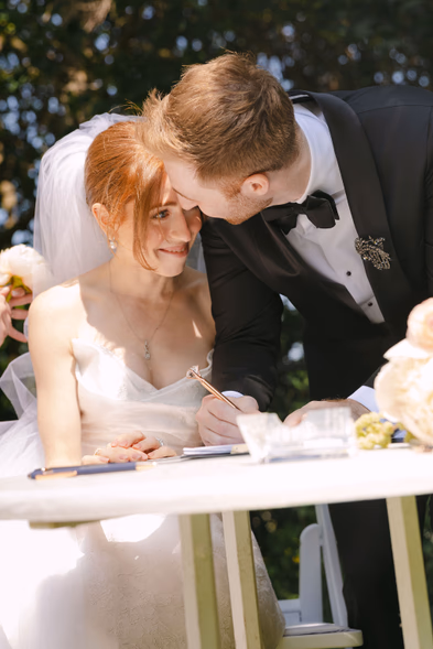 bride signing wedding registry intimate candid moment outdoor reception