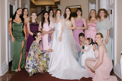 bride with bridesmaids group portrait colorful dresses wedding reception