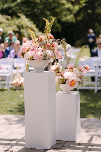 ceremony floral arrangements on pedestals garden wedding decor Queen’s Landing